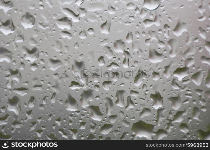 Glass surface with water drops in a rainy day