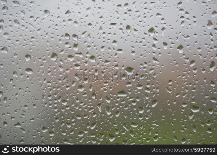 Glass surface with water drops in a rainy day