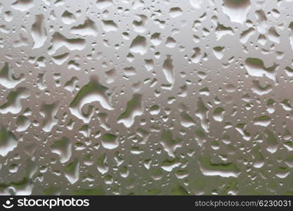 Glass surface with water drops in a rainy day