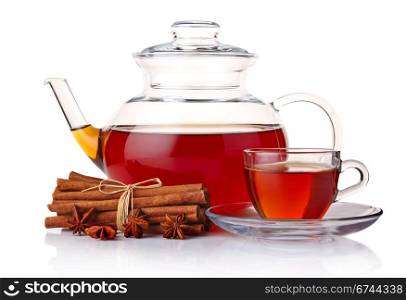 Glass teapot and cup of tea with spices isolated on white background