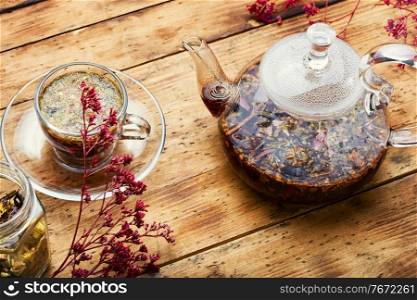 Glass teapot and cup with flower tea. Delicious herbal tea