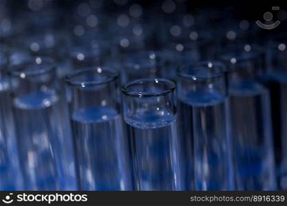 Glass test tubes filled with liquid on rack for an experiment in science research lab