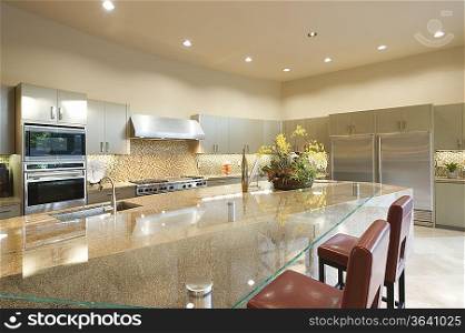 Glass topped kitchen surface with stainless steel fitted units
