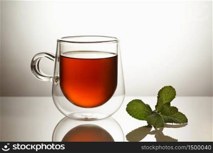 Glass transparent mug with tea, isolated