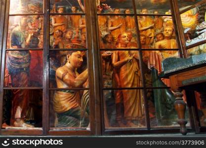 Glass wall and statues in cave Mulkirigala, Sri Lanka