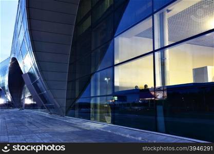 Glass wall of airport building at sunrise