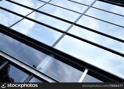 Glass wall of business center and sky reflection, may be used as background