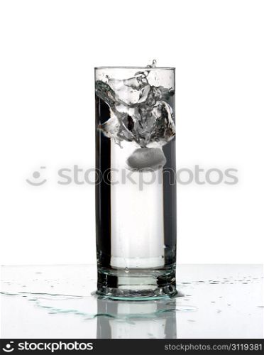 Glass with a water and ice, isolated on a white background.