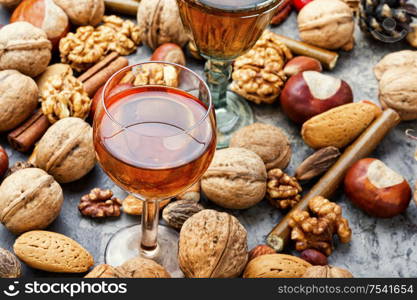 Glass with aromatic alcohol from nuts.Fragrant nutty liquor tincture.. Autumn nutty liquor