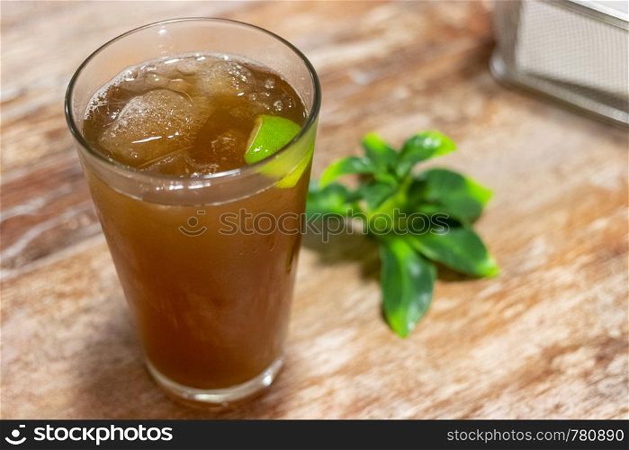 Glass with ice tea with lemon