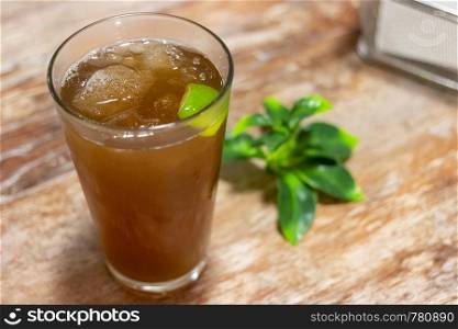 Glass with ice tea with lemon