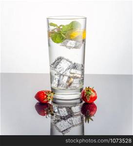 Glass with mineral water lemon and mint on a dark background. Glass with mineral water lemon and mint