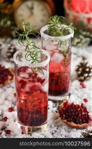 Glass with pomegranate Margarita with candied cranberries, rosemary. Perfect cocktail for a Christmas party