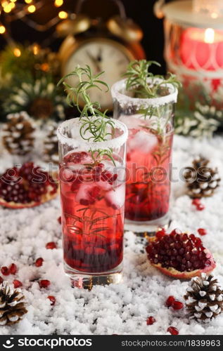 Glass with pomegranate Margarita with candied cranberries, rosemary. Perfect cocktail for a Christmas party