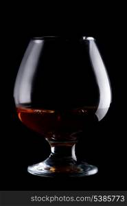 Glass with whisky isolated on black