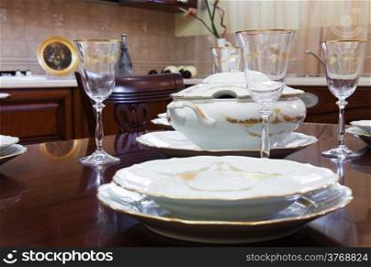 glasses and plates on a wooden table