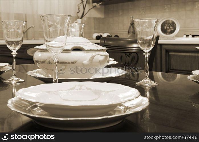 glasses and plates on a wooden table