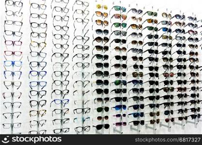 glasses background. glasses displayed. eye glasses on the shelf. eyeglass at an opticians store