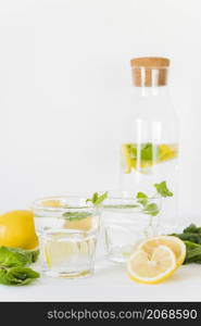 glasses bottle with lemon mint drink