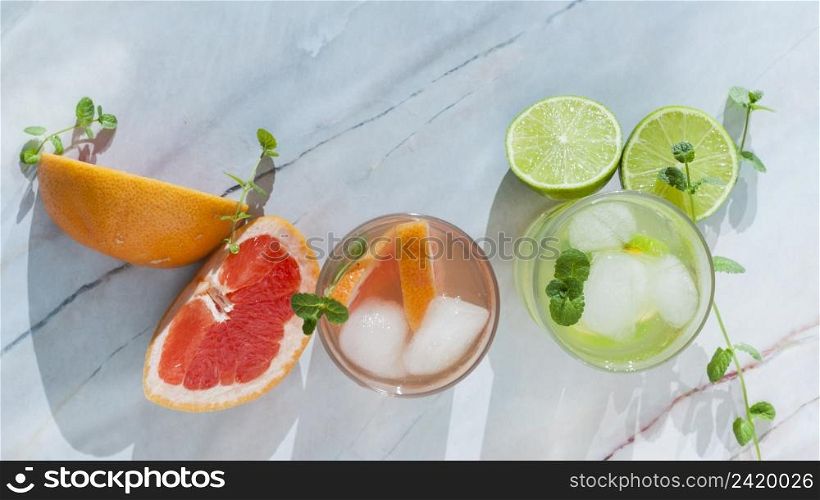 glasses citrus drink with sliced fruit