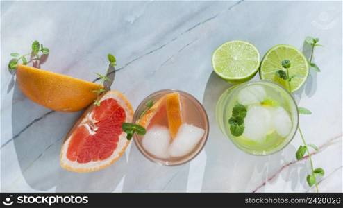 glasses citrus drink with sliced fruit