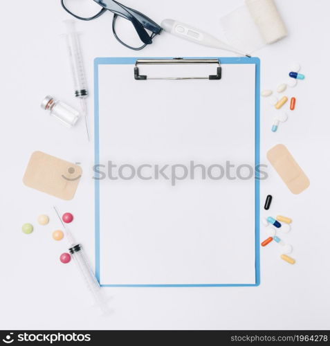 glasses medications around clipboard. High resolution photo. glasses medications around clipboard. High quality photo