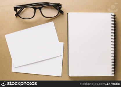 glasses near notebook paper sheets