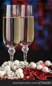 Glasses of a champagne. A christmas drink on the dim color background