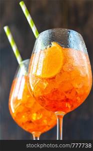 Glasses of Aperol Spritz cocktail on the rustic background