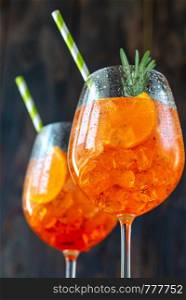Glasses of Aperol Spritz cocktail on the rustic background