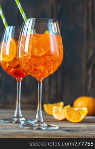 Glasses of Aperol Spritz cocktail on the rustic background