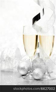 Glasses of ch&agne and  christmas decorative balls on glitter background