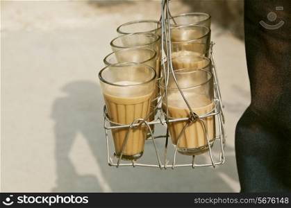 Glasses of chai in metal grid tray