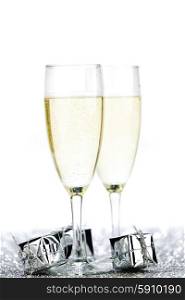 Glasses of champagne and christmas gifts on silver background. Champagne and gifts