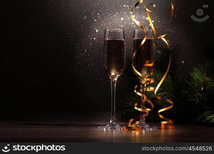 Glasses of champagne at new year party. Two champagne glasses ready to bring in the New Year