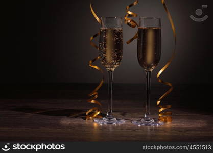 Glasses of champagne at new year party. Two champagne glasses ready to bring in the New Year