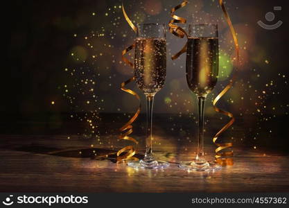 Glasses of champagne at new year party. Two champagne glasses ready to bring in the New Year