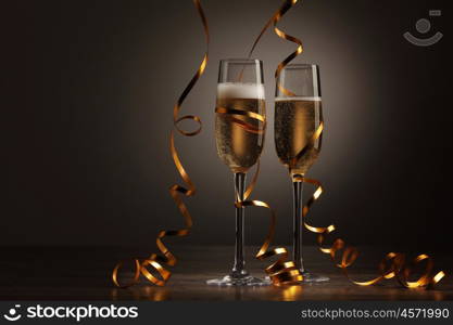 Glasses of champagne at new year party. Two champagne glasses ready to bring in the New Year