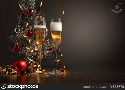 Glasses of champagne at new year party. Two champagne glasses ready to bring in the New Year