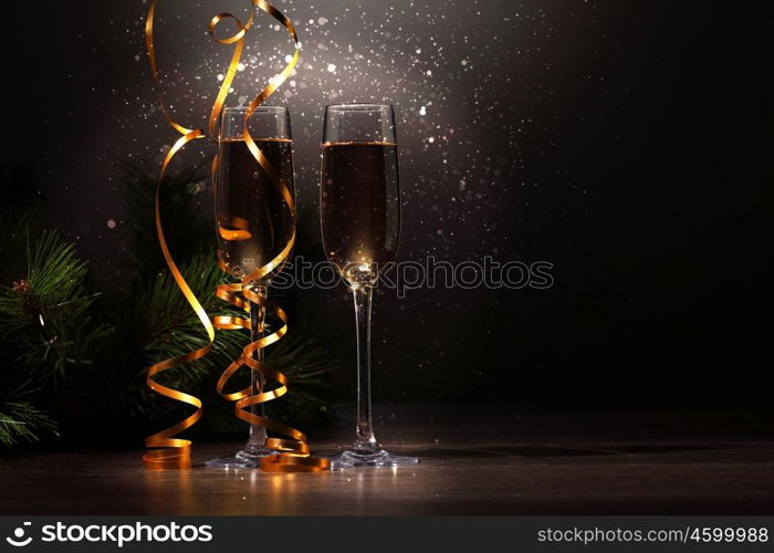 Glasses of champagne at new year party. Two champagne glasses ready to bring in the New Year