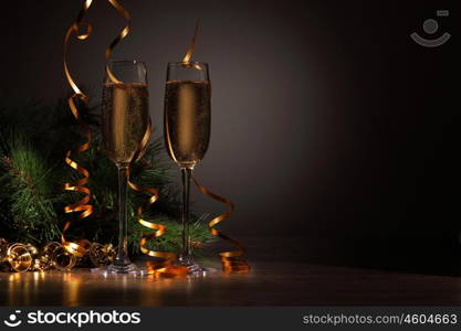 Glasses of champagne at new year party. Two champagne glasses ready to bring in the New Year