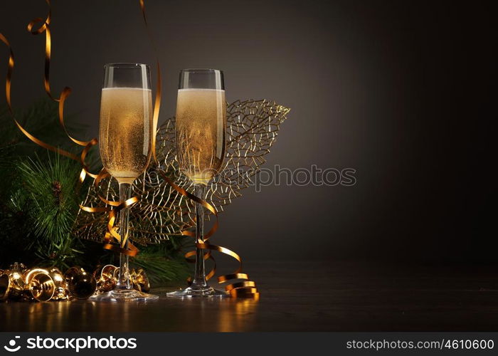 Glasses of champagne at new year party. Two champagne glasses ready to bring in the New Year