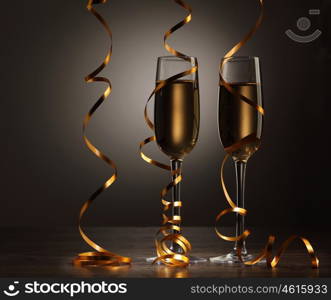 Glasses of champagne at new year party. Two champagne glasses ready to bring in the New Year