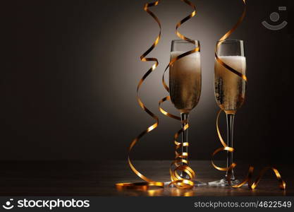 Glasses of champagne at new year party. Two champagne glasses ready to bring in the New Year