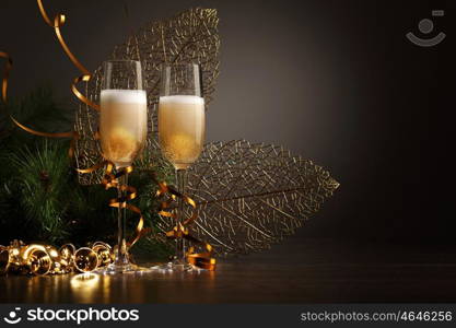 Glasses of champagne at new year party. Two champagne glasses ready to bring in the New Year