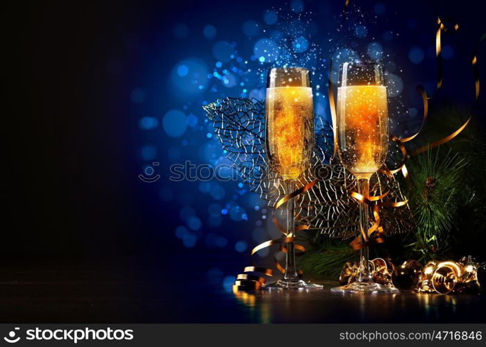 Glasses of champagne at new year party. Two champagne glasses ready to bring in the New Year