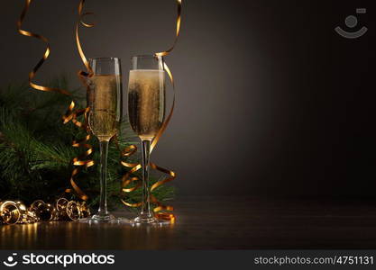 Glasses of champagne at new year party. Two champagne glasses ready to bring in the New Year