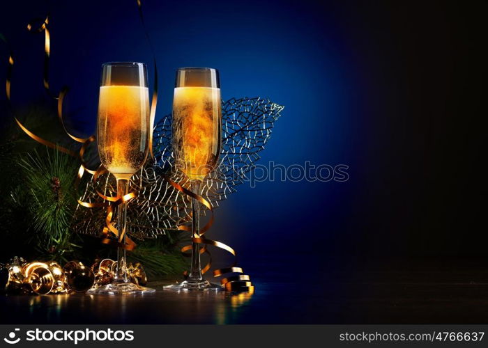 Glasses of champagne at new year party. Two champagne glasses ready to bring in the New Year