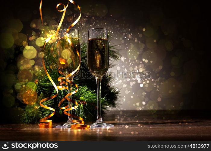 Glasses of champagne at new year party. Two champagne glasses ready to bring in the New Year