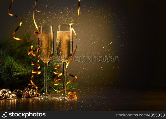 Glasses of champagne at new year party. Two champagne glasses ready to bring in the New Year